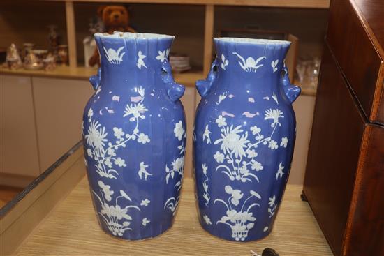 A pair of 19th century Chinese blue ground vases, with white floral decoration